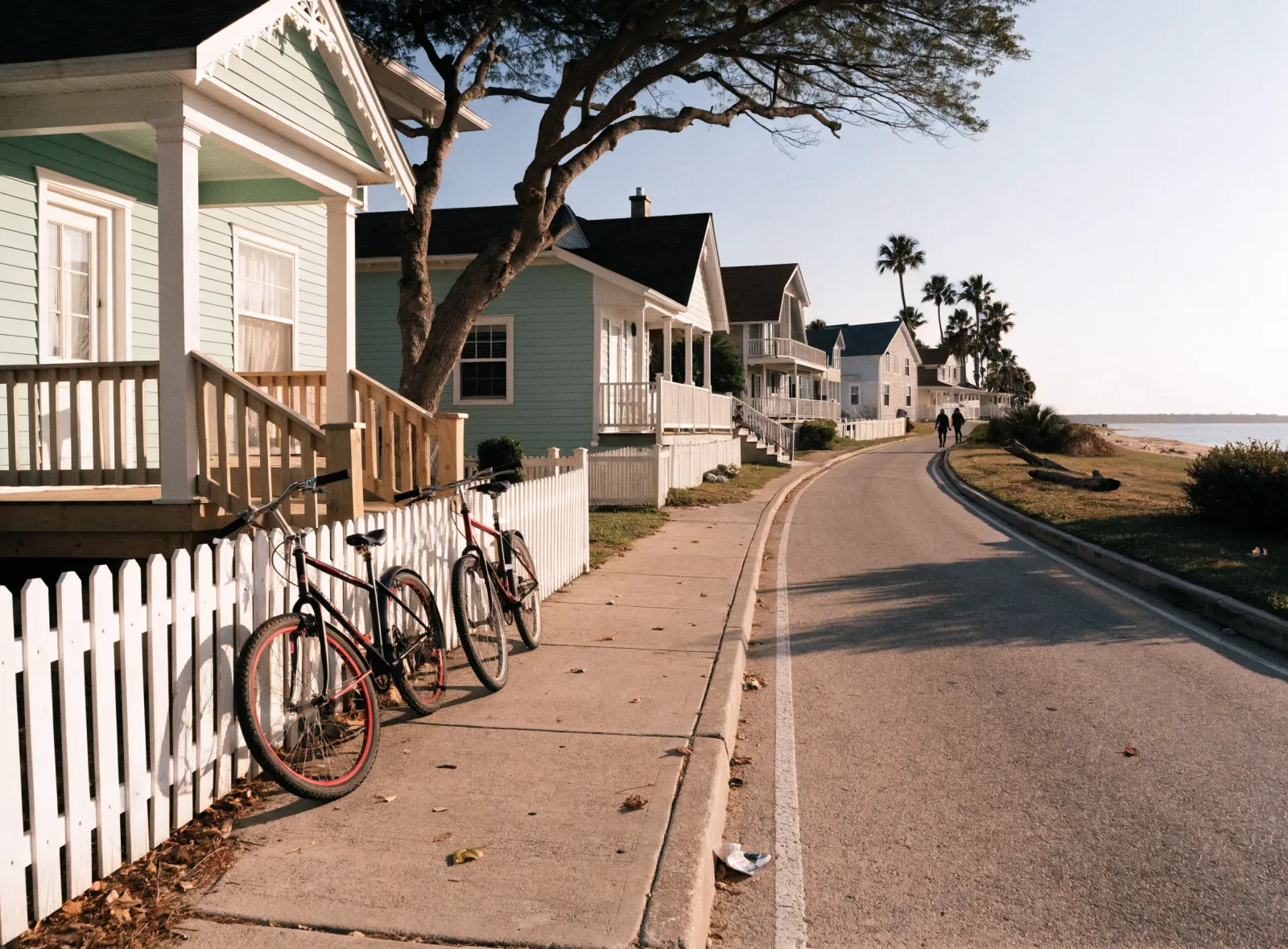 Pastel cottages and cruiser bikes on a quiet 30A lane in morning light